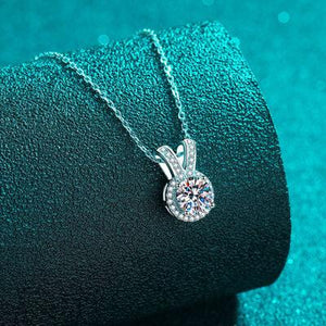 a close up of a diamond pendant on a chain