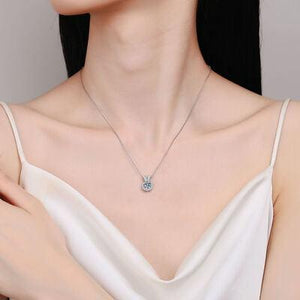 a woman in a white dress wearing a diamond necklace