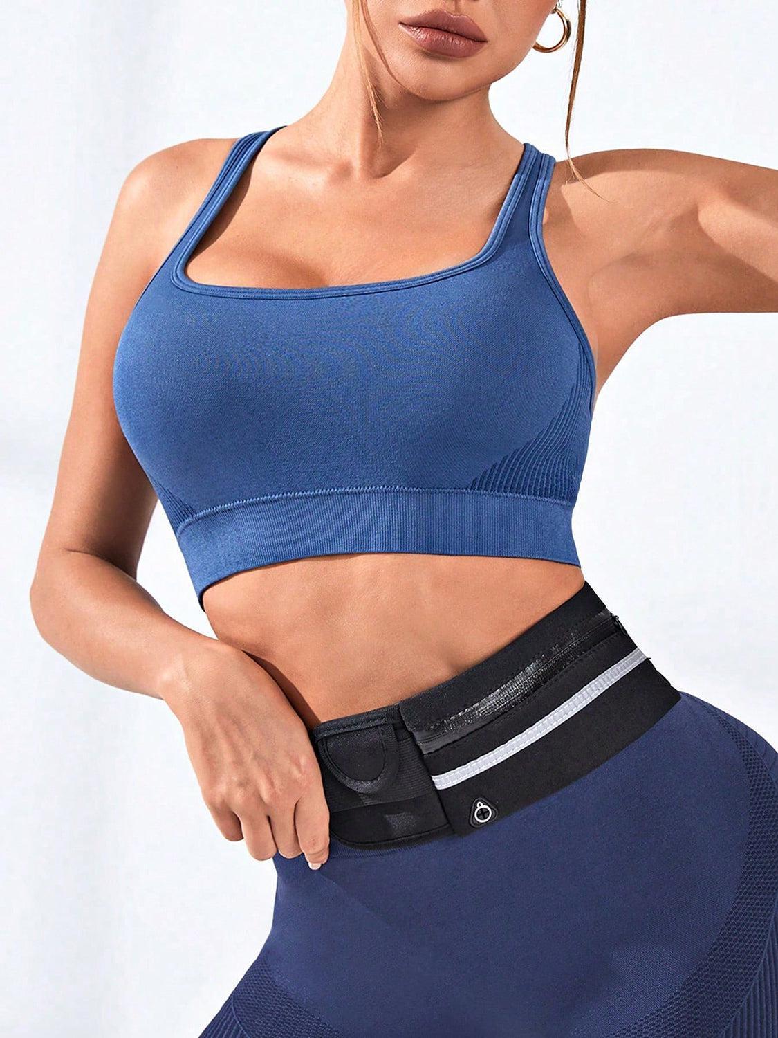 a woman in a blue sports bra top posing for a picture
