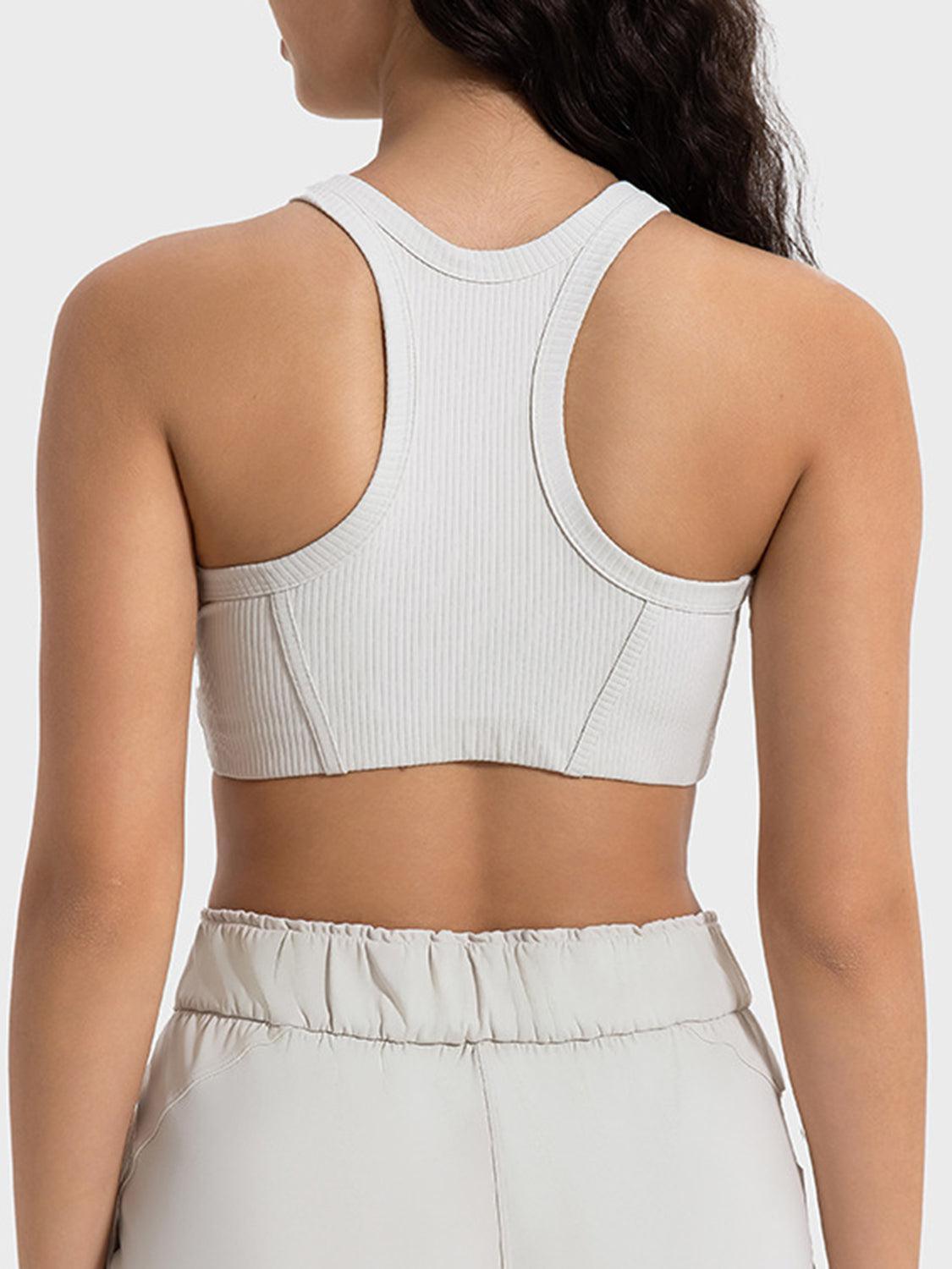 the back of a woman wearing a white crop top