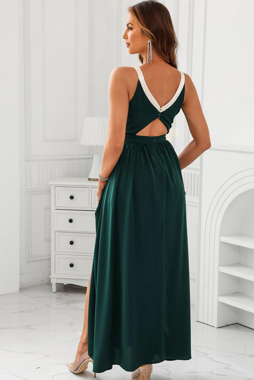 a woman wearing a green dress with a cut out back