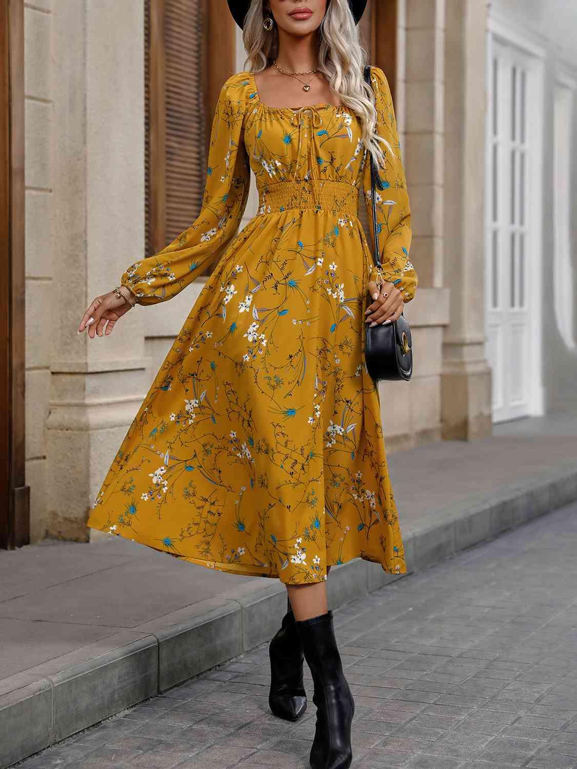 a woman wearing a yellow dress and black hat