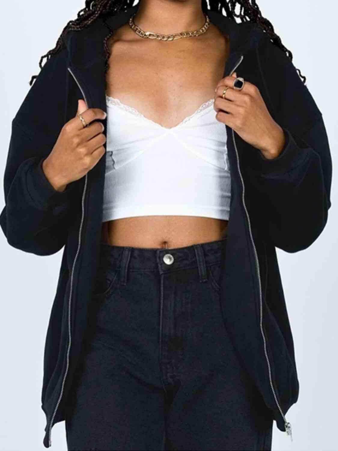 a woman wearing a white top and black pants