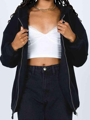 a woman wearing a white top and black pants