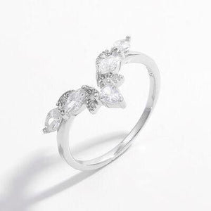 a white gold ring with three pear shaped diamonds