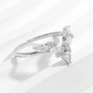 a white gold ring with three pear shaped diamonds