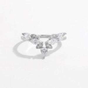 a white gold ring with three pear shaped diamonds