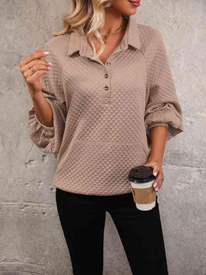 a woman holding a cup of coffee in her hand