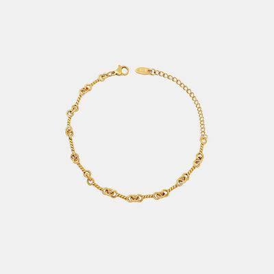 a gold bracelet on a white background