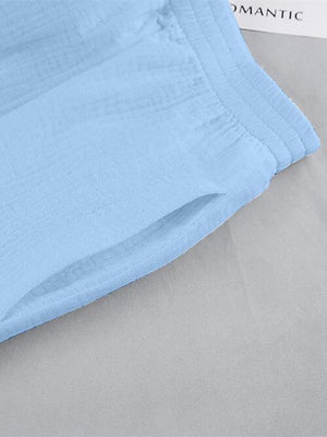 a close up of a blue sheet on a bed