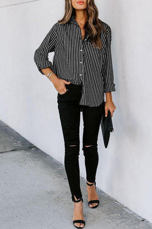 a woman wearing a black and white striped shirt