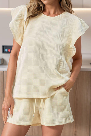 a woman wearing a short sleeve top and shorts