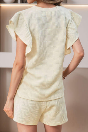 a woman wearing a short sleeved top and shorts