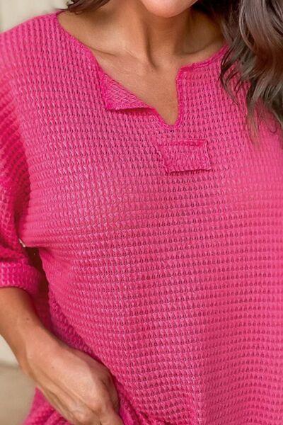 a woman wearing a pink top and jeans