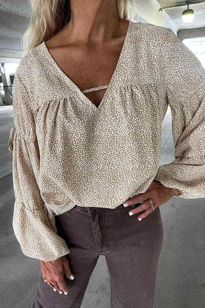 a woman wearing a white blouse and brown pants