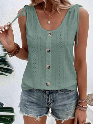 a woman wearing a green top and denim shorts