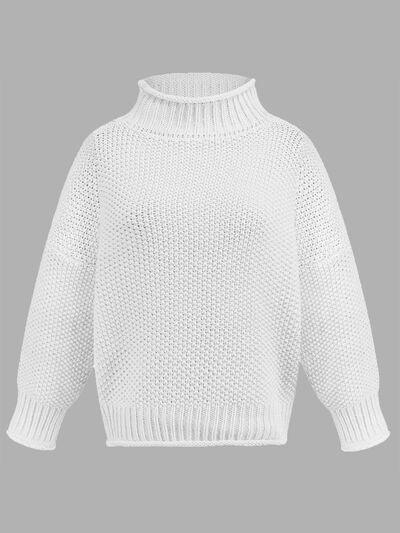 a white sweater with a high neck and long sleeves