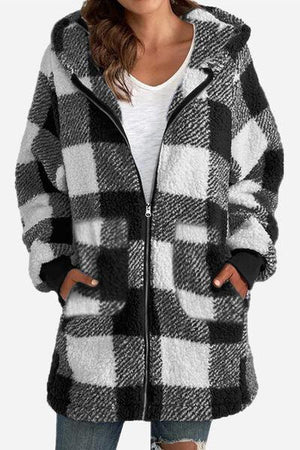 a woman wearing a black and white checkered coat