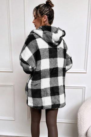 a woman wearing a black and white checkered coat
