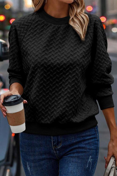 a woman walking down the street holding a cup of coffee