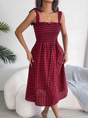 a woman in a red and black checkered dress