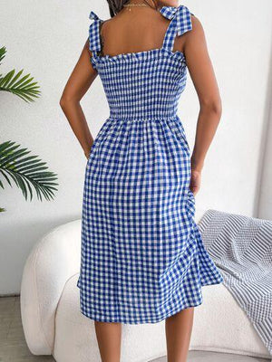 a woman in a blue and white checkered dress