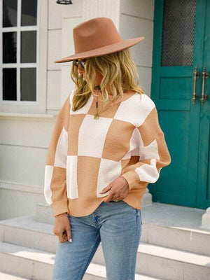 a woman wearing a brown and white checkered sweater