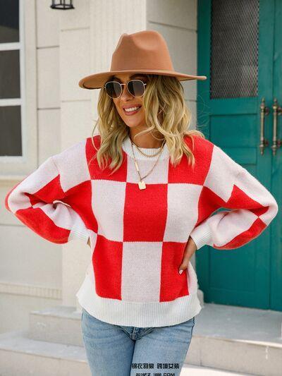 a woman wearing a red and white checkered sweater