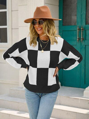 a woman wearing a black and white checkered sweater