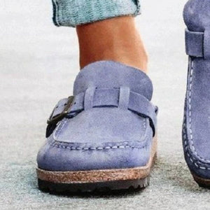 a close up of a person wearing blue shoes