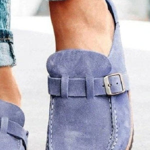 a close up of a person wearing blue shoes