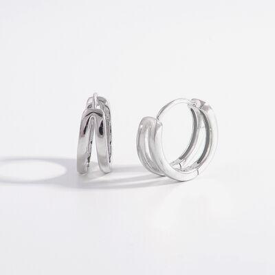 a pair of silver hoop earrings on a white background