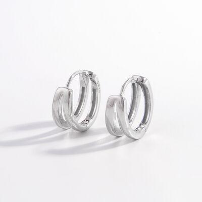 a pair of silver hoop earrings on a white background