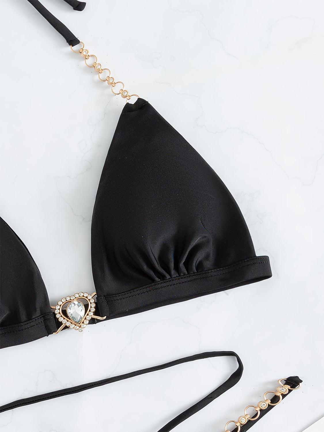 a black bikini top with a chain attached to it