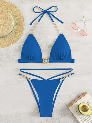 a blue bikini top and a straw hat