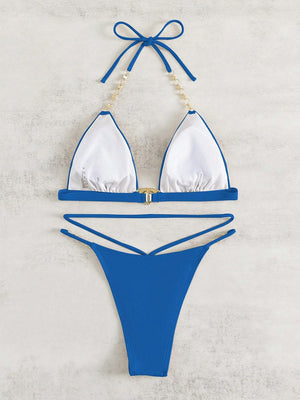 a blue and white bikini with pearls on the side