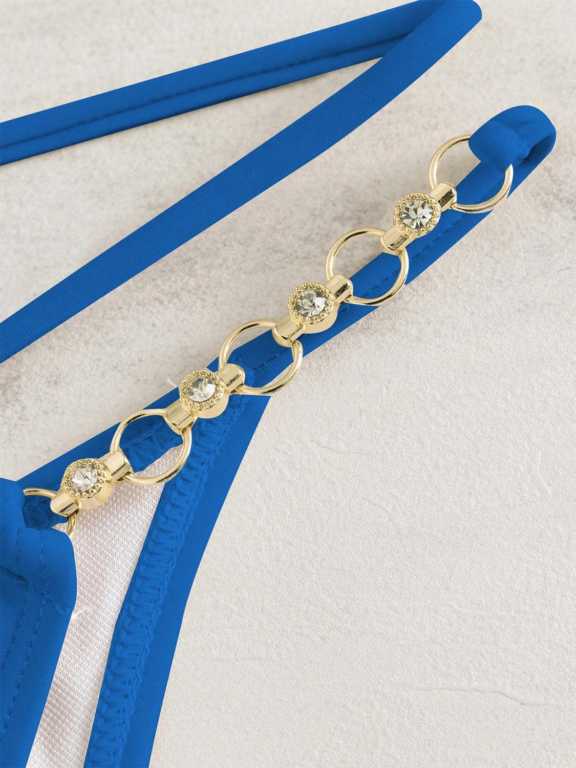 a close up of a blue belt with a gold chain