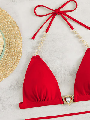 a red bikini top and a straw hat