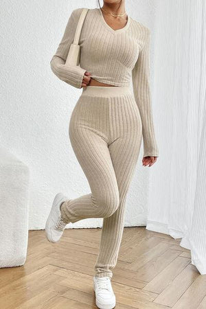 a woman in a beige sweater and pants