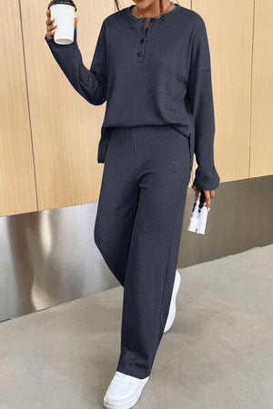 a woman holding a cup of coffee and a cell phone