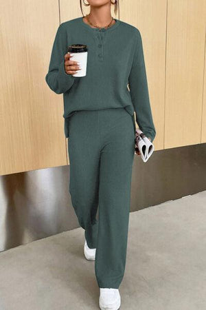 a woman in a green outfit holding a cup of coffee