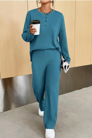 a woman in a teal outfit holding a cup of coffee