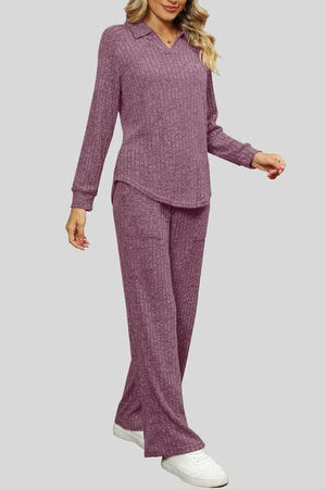 a woman in a purple sweater and pants