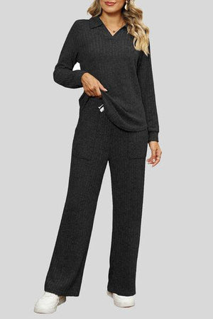 a woman wearing a black sweater and pants