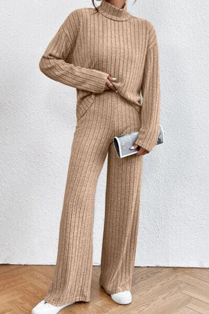 a woman in a tan sweater and pants