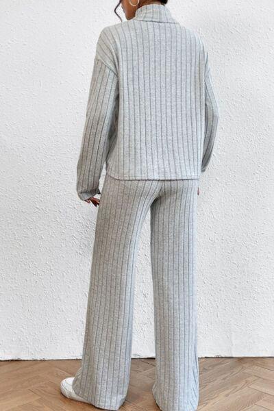 a woman wearing a gray sweater and pants