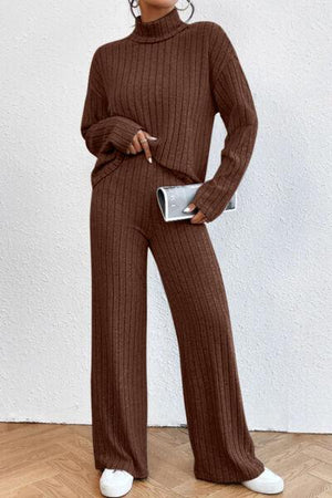 a woman in a brown sweater and pants