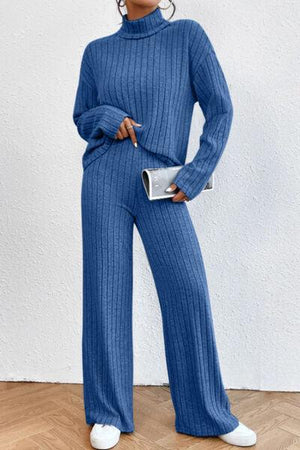 a woman in a blue sweater and pants
