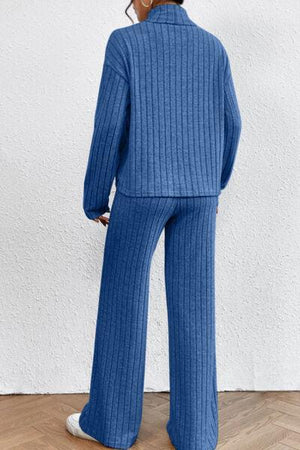 a woman wearing a blue sweater and pants