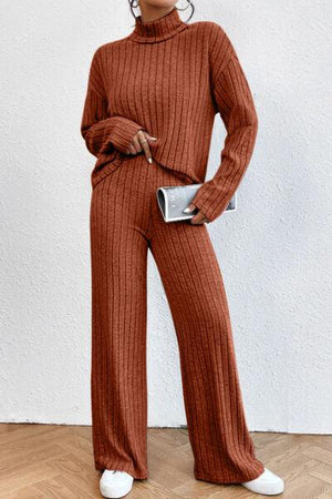 a woman in a brown sweater and pants